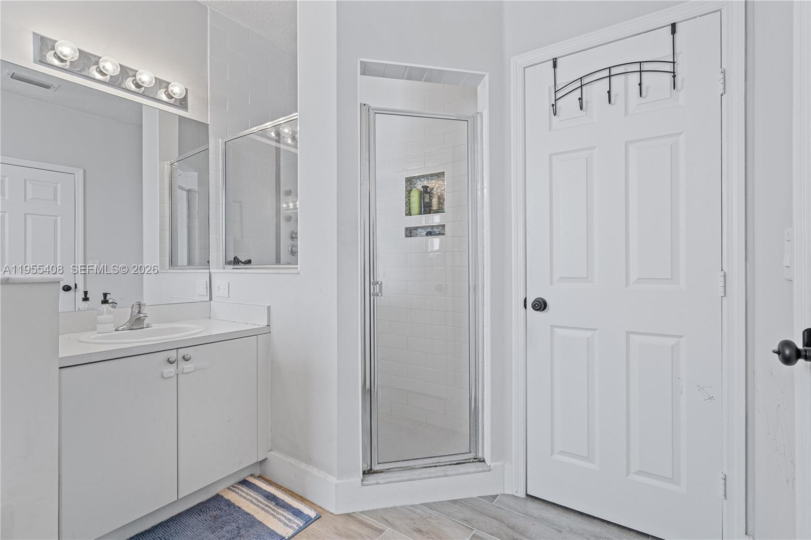 1940 Southeast 24th Terrace Homestead, FL 33035 - Photo 14 of 29 a bathroom with a double vanity sink and a mirror