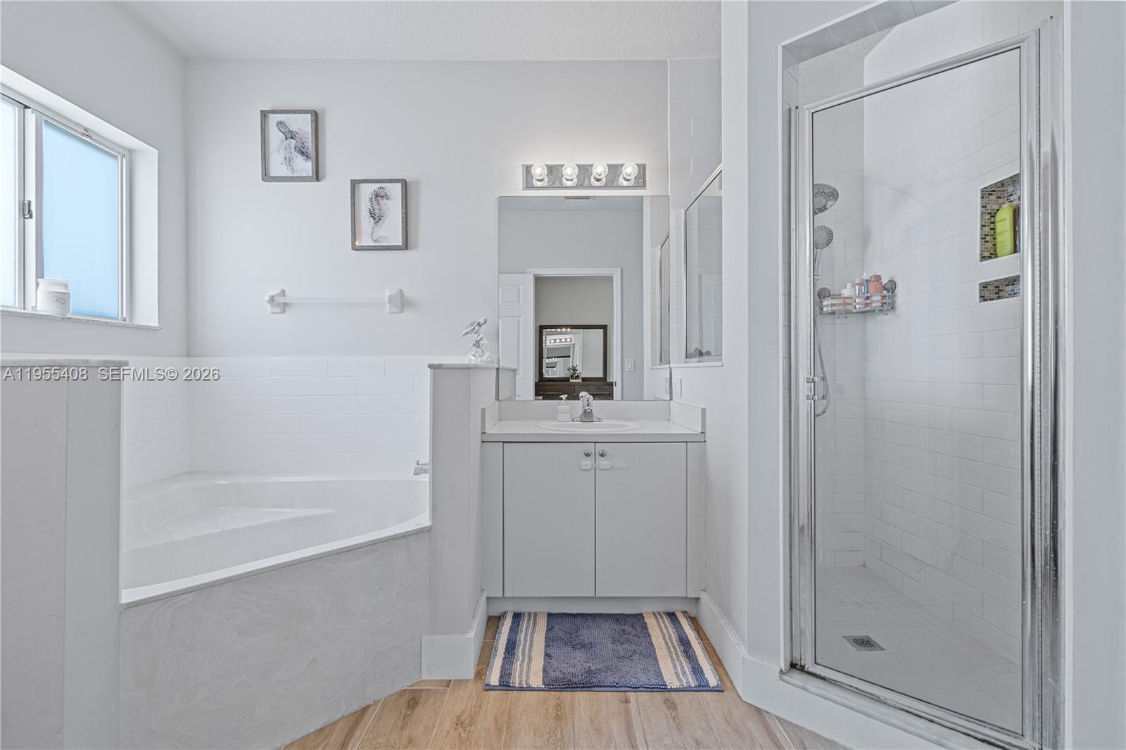 1940 Southeast 24th Terrace Homestead, FL 33035 - Photo 15 of 29 a bathroom with a sink a mirror a vanity and a bathtub