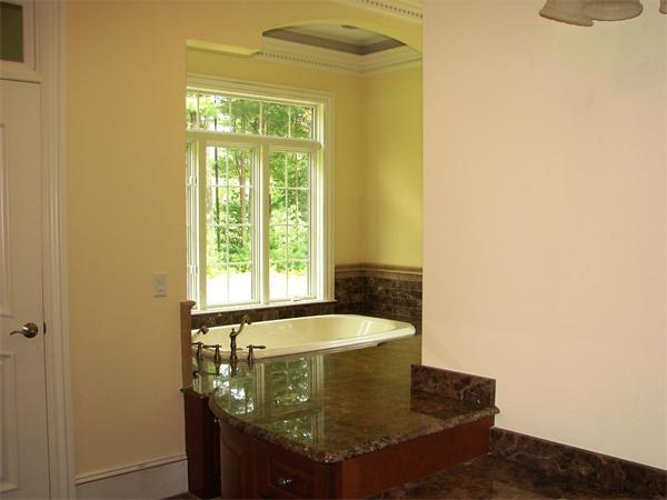 95 Fox Run Road Bolton, MA 01740 - Photo 15 of 25 a bath tub sitting in a bathroom next to a window