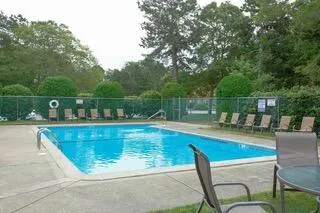 a view of a swimming pool with a table and chairs