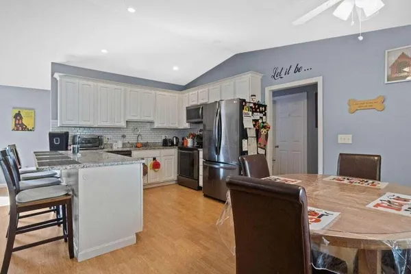 a kitchen with a refrigerator and a stove top oven