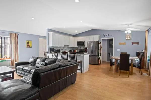 a living room with furniture and kitchen view