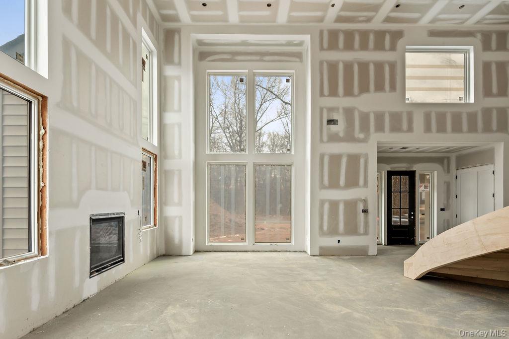 94 Viola Road Suffern, NY 10901 - Photo 8 of 19 a view of a hallway with a fireplace and a window