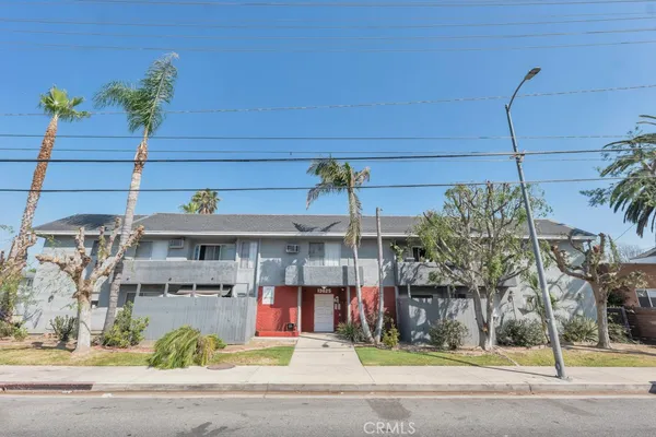 a front view of a building with small garden