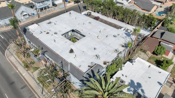 an aerial view of a house with a yard and large trees