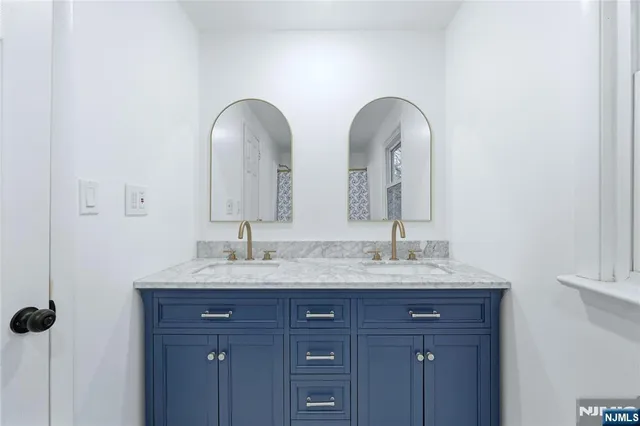 a bathroom with a granite countertop sink a large mirror and