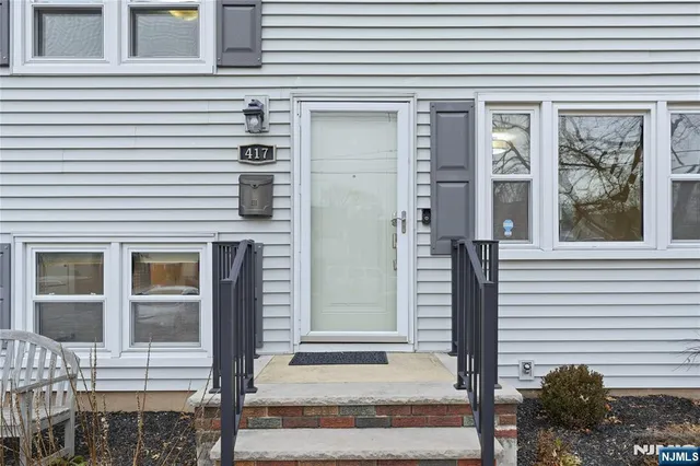 a front view of a house with a iron gate