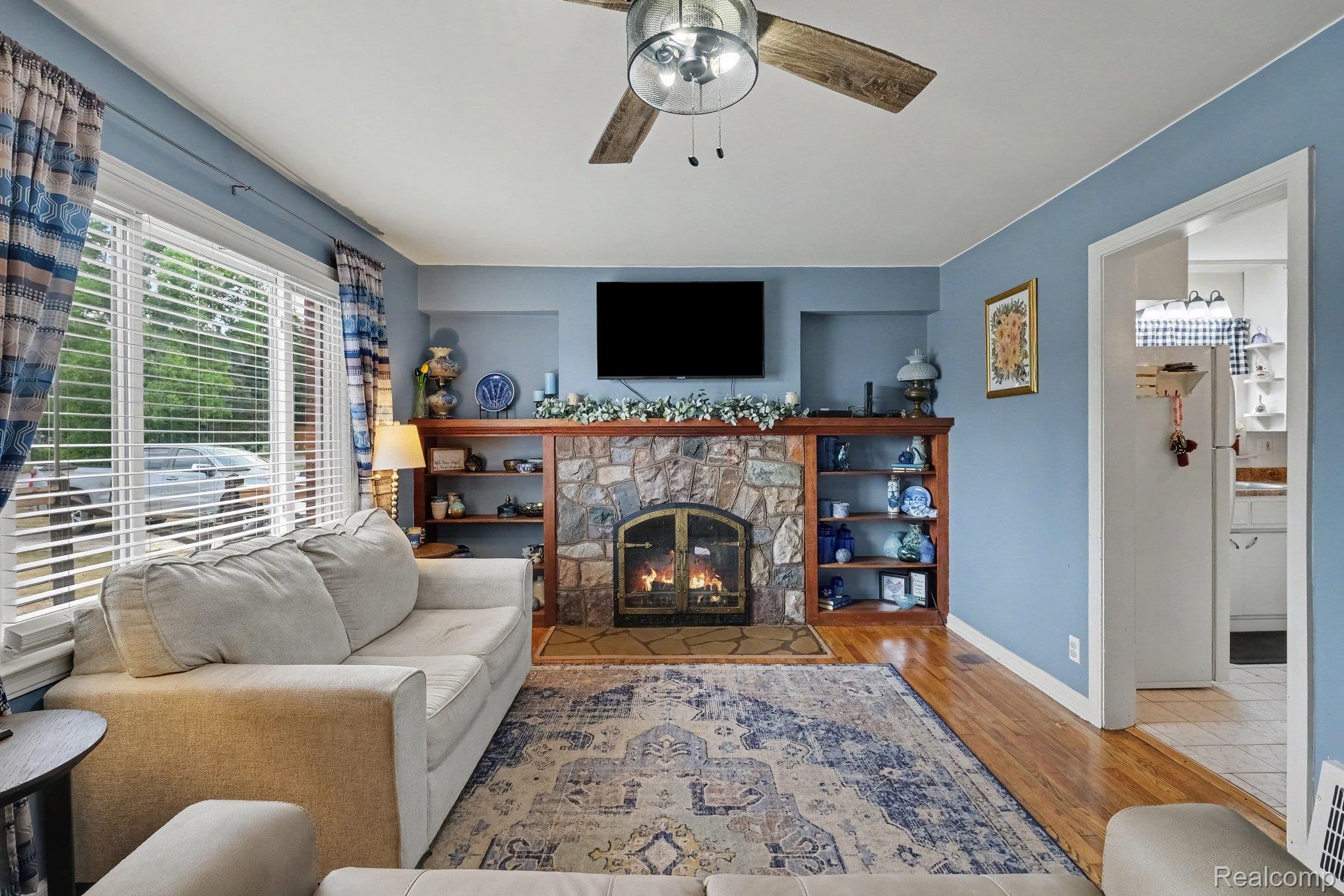 5409 Baldwin Road Swartz Creek, MI 48473 - Photo 3 of 27 Stone fireplace with wood mantel and built-in shelving