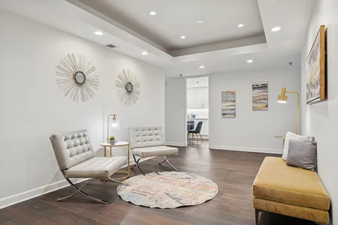 a living room with furniture and a wooden floor
