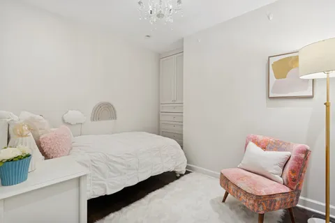 a bedroom with a bed and a chair