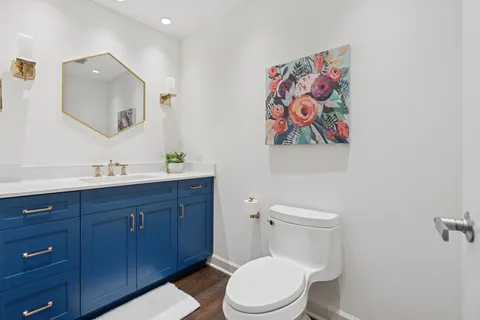 a bathroom with a toilet a sink and mirror