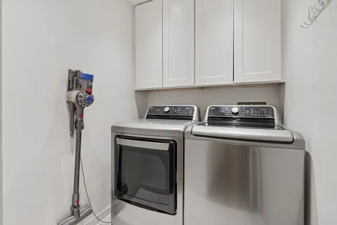 a kitchen with a stove and white cabinets
