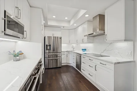 a kitchen with a sink stainless steel appliances and cabinets