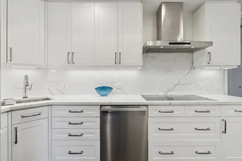 a kitchen with cabinets appliances and a sink