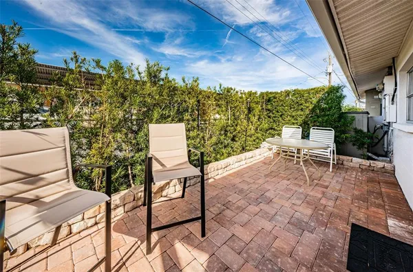 a backyard of a house with table and chairs