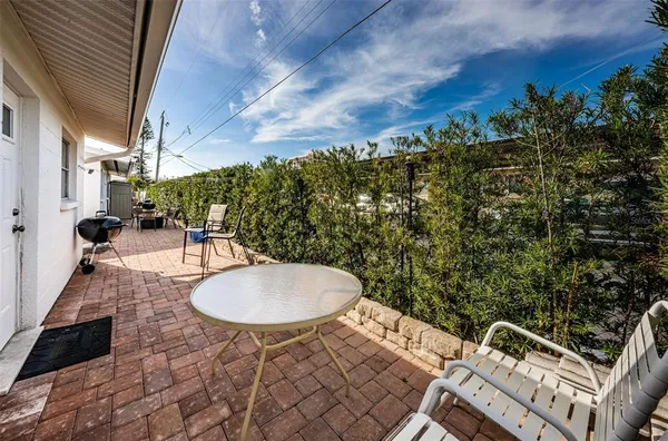 a view of a house with backyard and sitting area