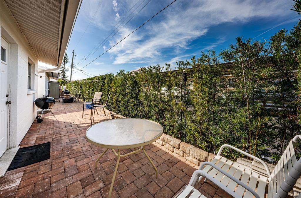 6020 Midnight Pass Road, Unit 14A Sarasota, FL 34242 - Photo 17 of 18 a backyard of a house with table and chairs