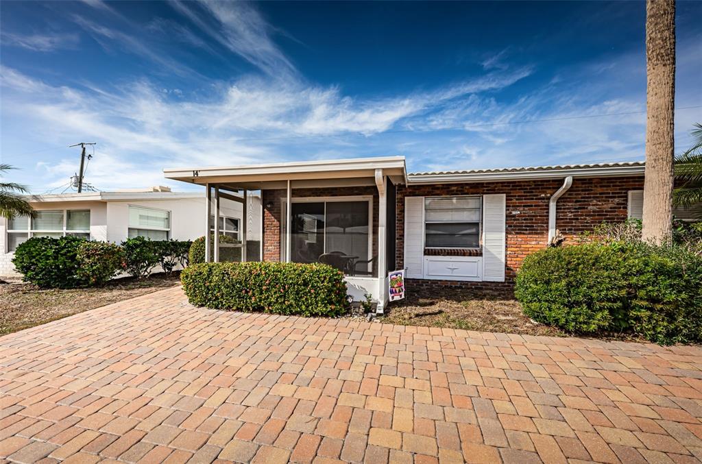 6020 Midnight Pass Road, Unit 14A Sarasota, FL 34242 - Photo 2 of 18 a view of a house with a yard