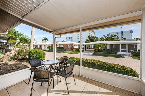 a view of a patio with table and chairs and potted plants