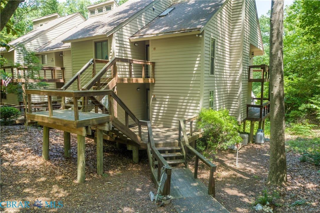 54 Villa Ridge Drive, Unit C Hartfield, VA 23071 - Photo 2 of 45 Rear view of house featuring a shingled roof and a wooden deck