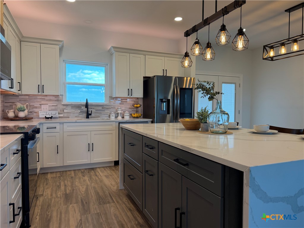15006 Armstrong Ests Road Salado, TX 76571 - Photo 7 of 29 a kitchen with a sink stainless steel appliances a counter space and cabinets