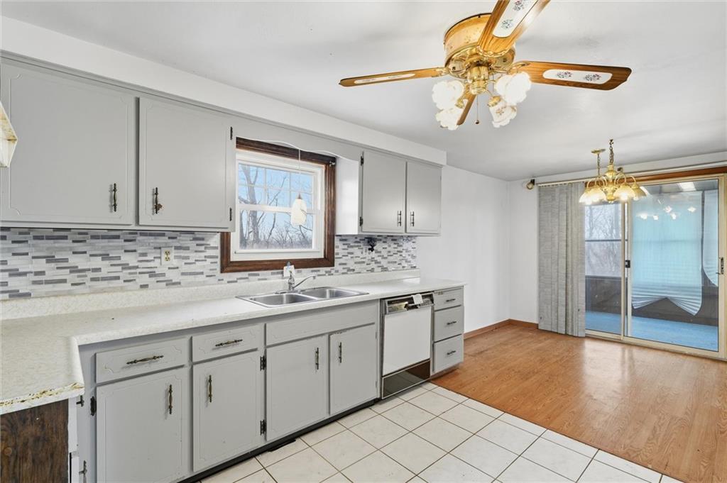 51 Revo Road Pittsburgh, PA 15236 - Photo 6 of 29 a bathroom with a sink a chandelier and bathtub