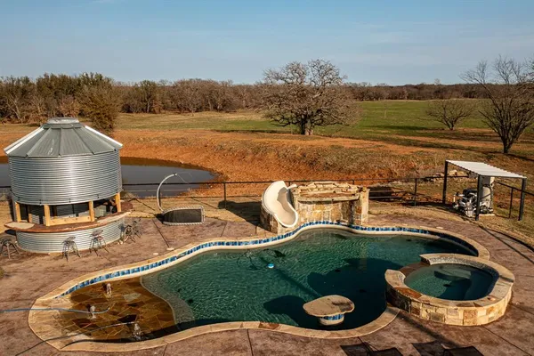 a view of a swimming pool with lawn chairs