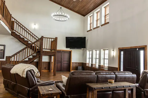 a living room with furniture a flat screen tv and a window