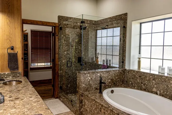 a bathroom with a bathtub and shower