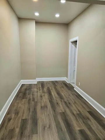 a view of room with wooden floor