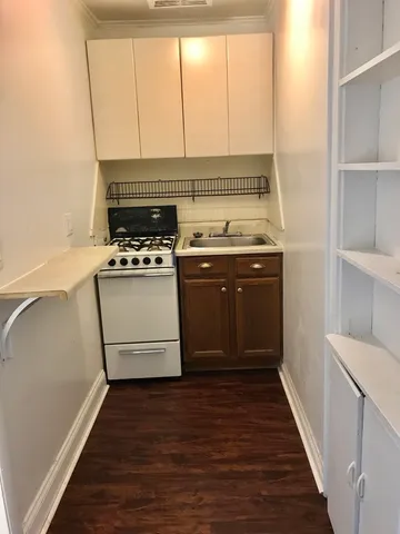 a kitchen with a stove top oven and sink