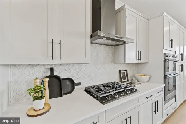 a kitchen with stainless steel appliances granite countertop a sink stove and cabinets