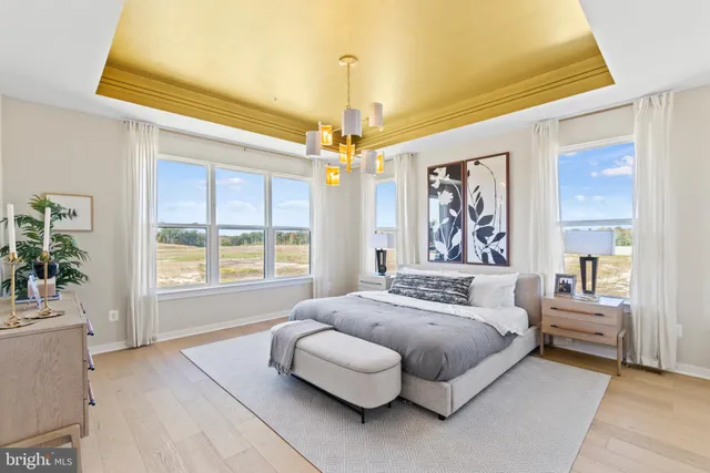 a spacious bedroom with a bed couch and window