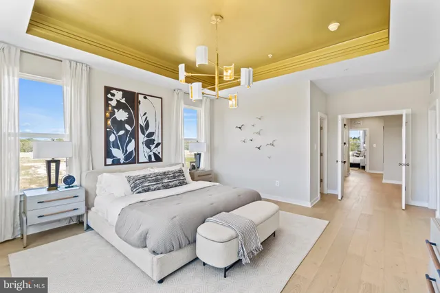 a bedroom with a bed and a chandelier