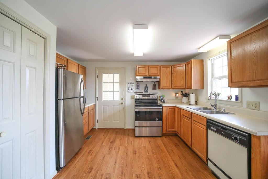 79 Cattle Scales Road Waynesboro, VA 22980 - Photo 13 of 39 a kitchen with a sink a window a refrigerator and stainless steel appliances