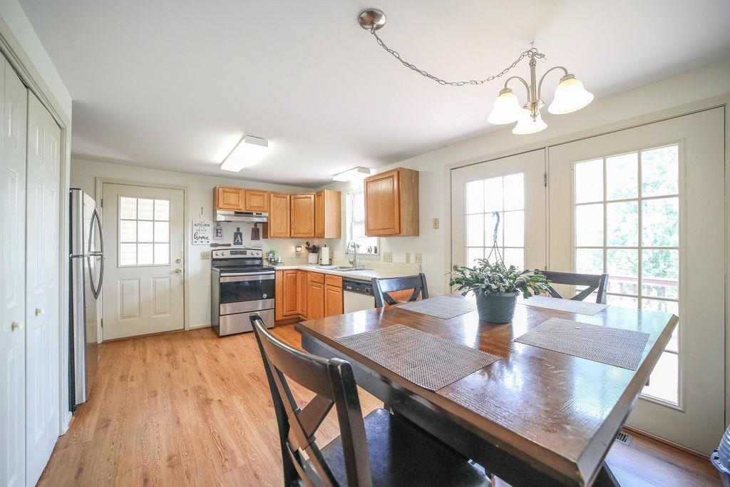 79 Cattle Scales Road Waynesboro, VA 22980 - Photo 16 of 39 a view of a dining room with furniture window and wooden floor