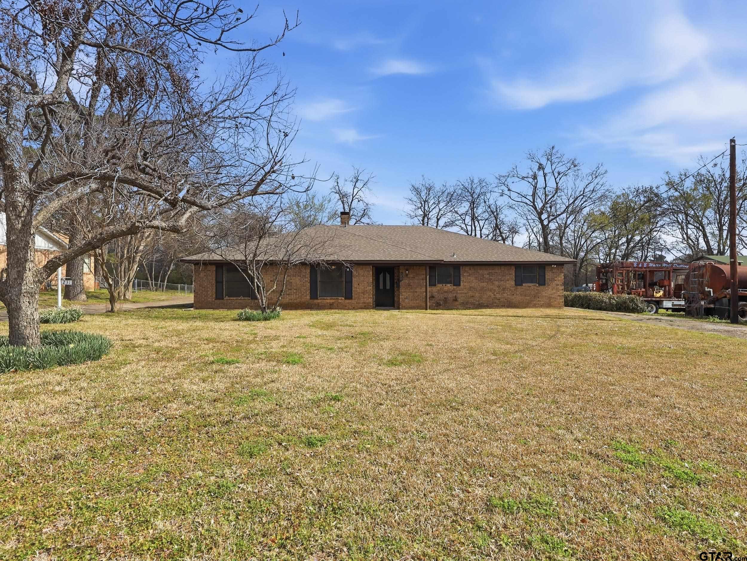 231 Quitman Street Pittsburg, TX 75686 - Photo 1 of 31 a front view of a house with a yard