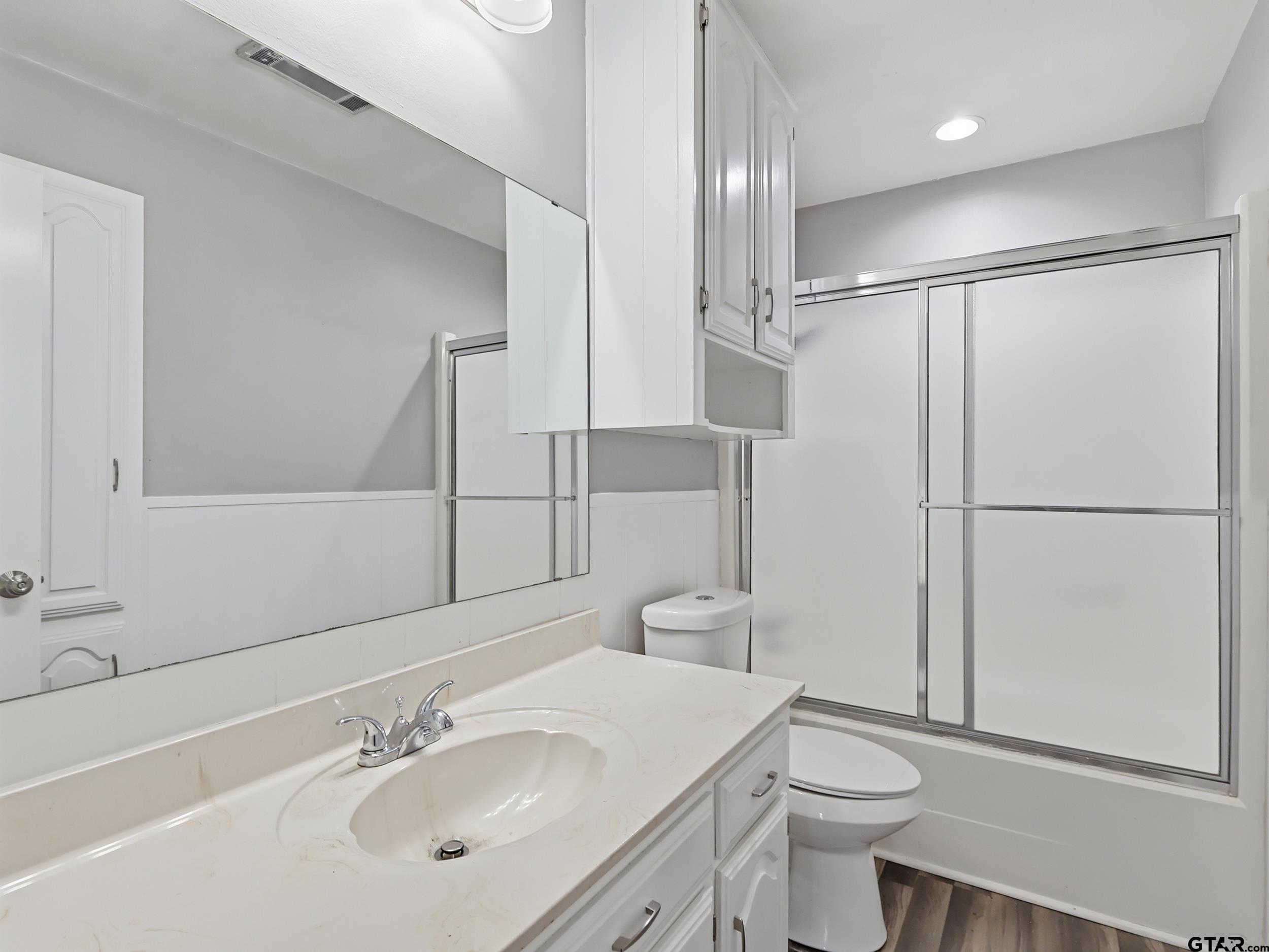 231 Quitman Street Pittsburg, TX 75686 - Photo 16 of 31 a bathroom with a sink toilet and shower