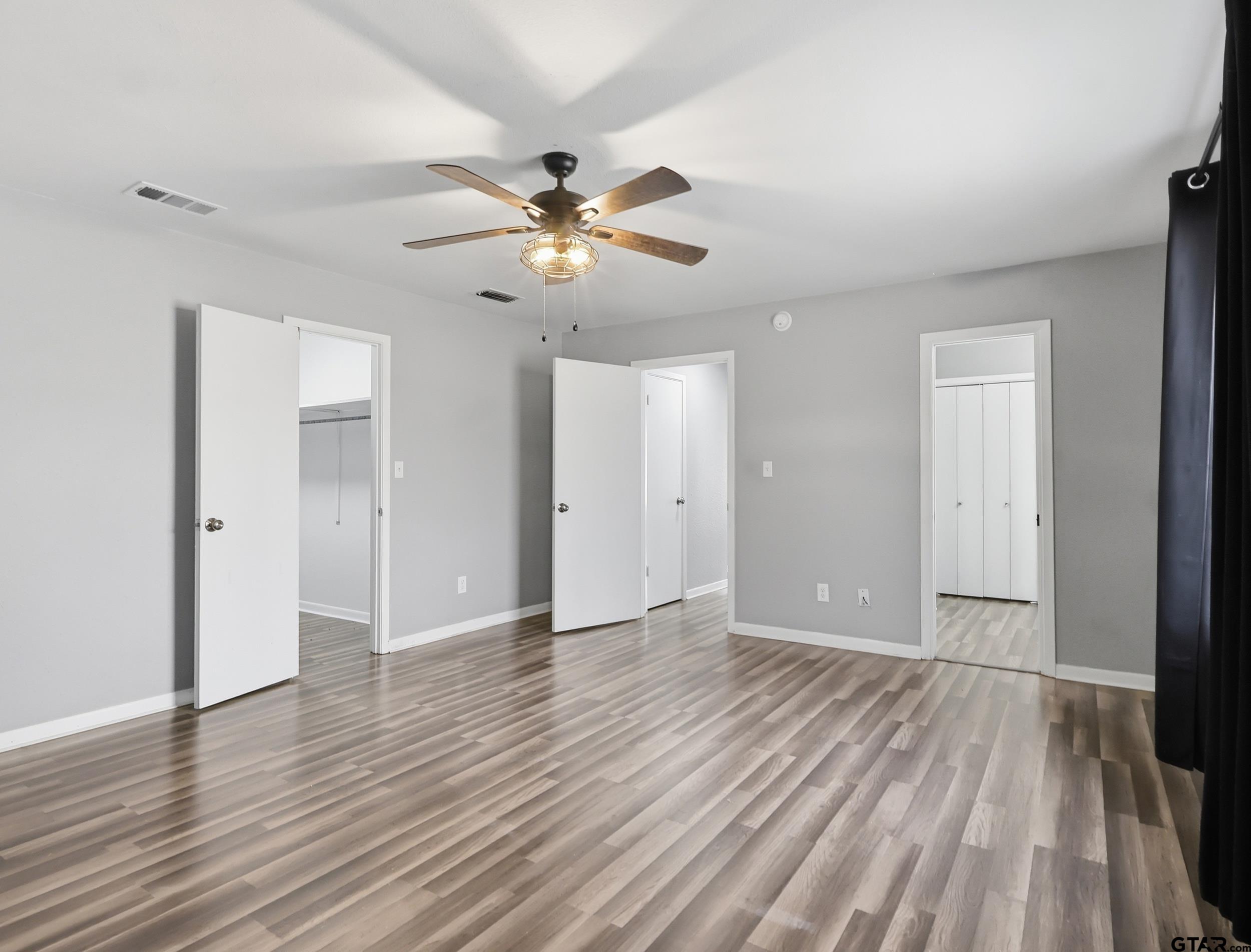 231 Quitman Street Pittsburg, TX 75686 - Photo 19 of 31 a view of an empty room with wooden floor