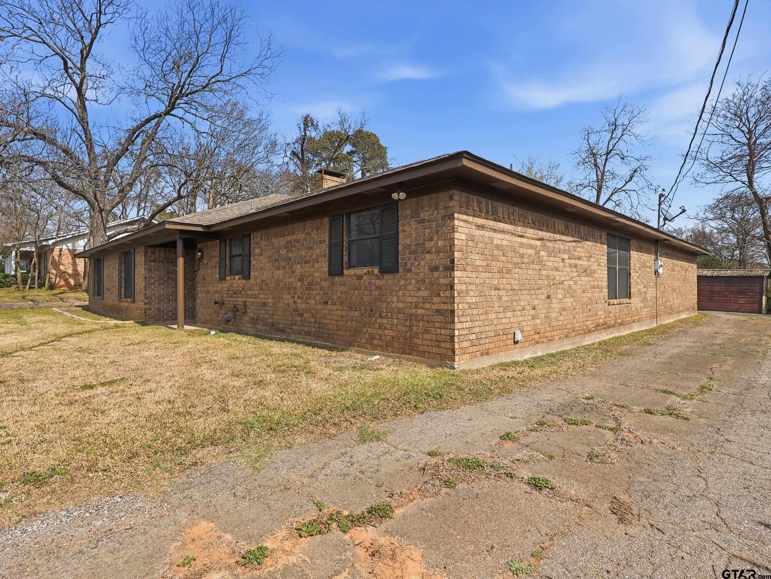 231 Quitman Street Pittsburg, TX 75686 - Photo 28 of 31 a front view of a house with a yard