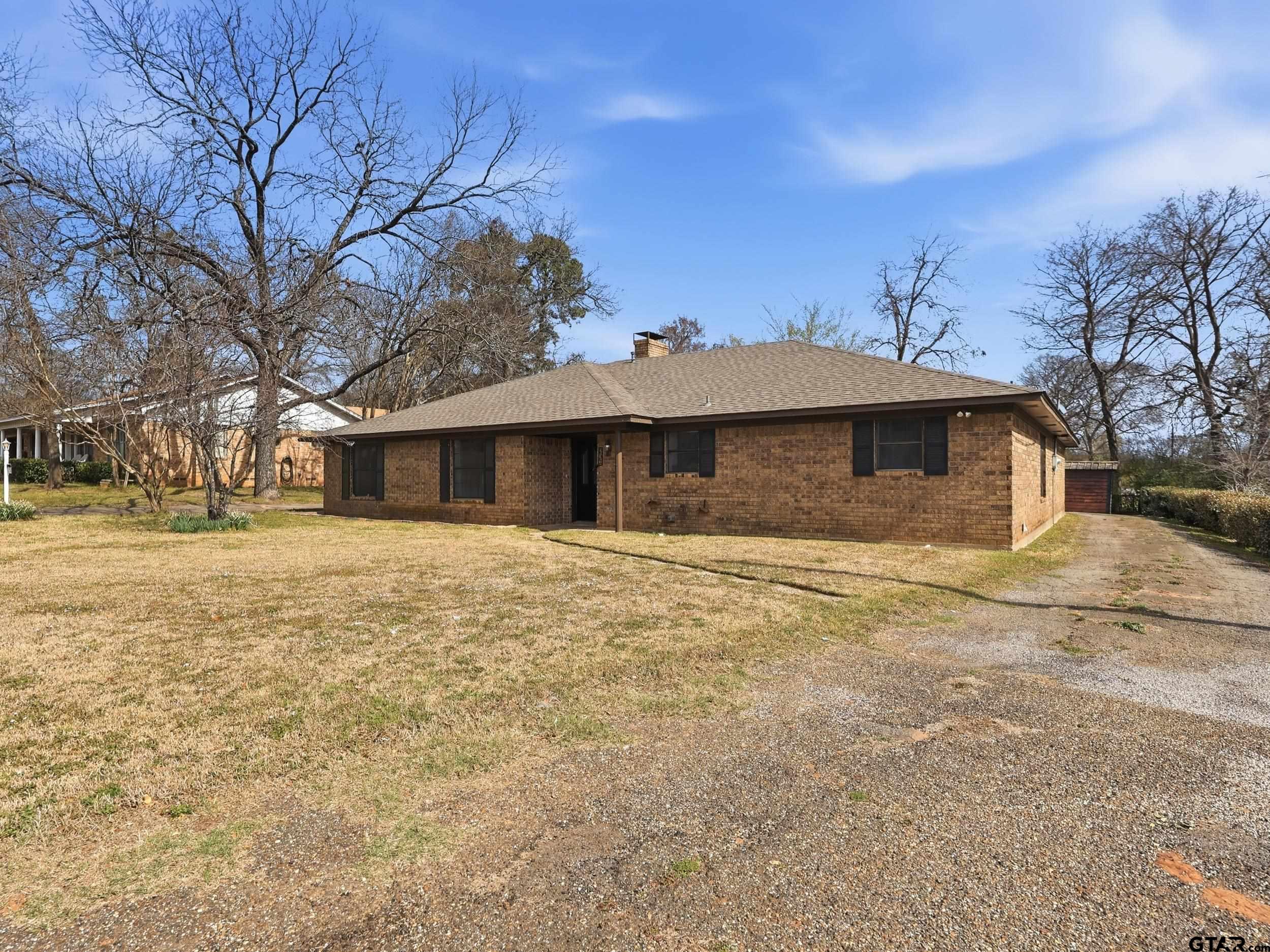 231 Quitman Street Pittsburg, TX 75686 - Photo 5 of 31 a front view of a house with a yard