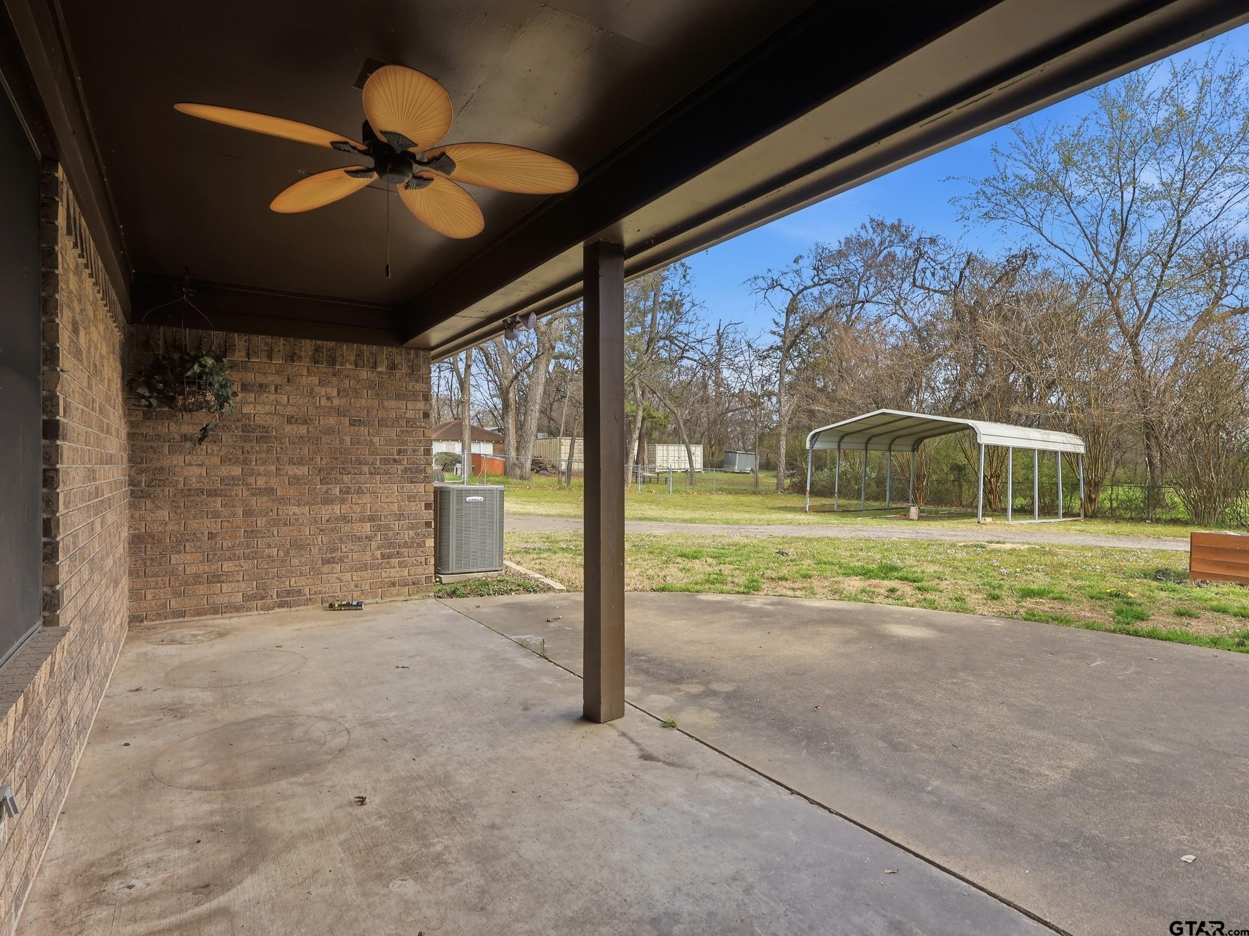 231 Quitman Street Pittsburg, TX 75686 - Photo 8 of 31 a view of a porch with a table and chairs