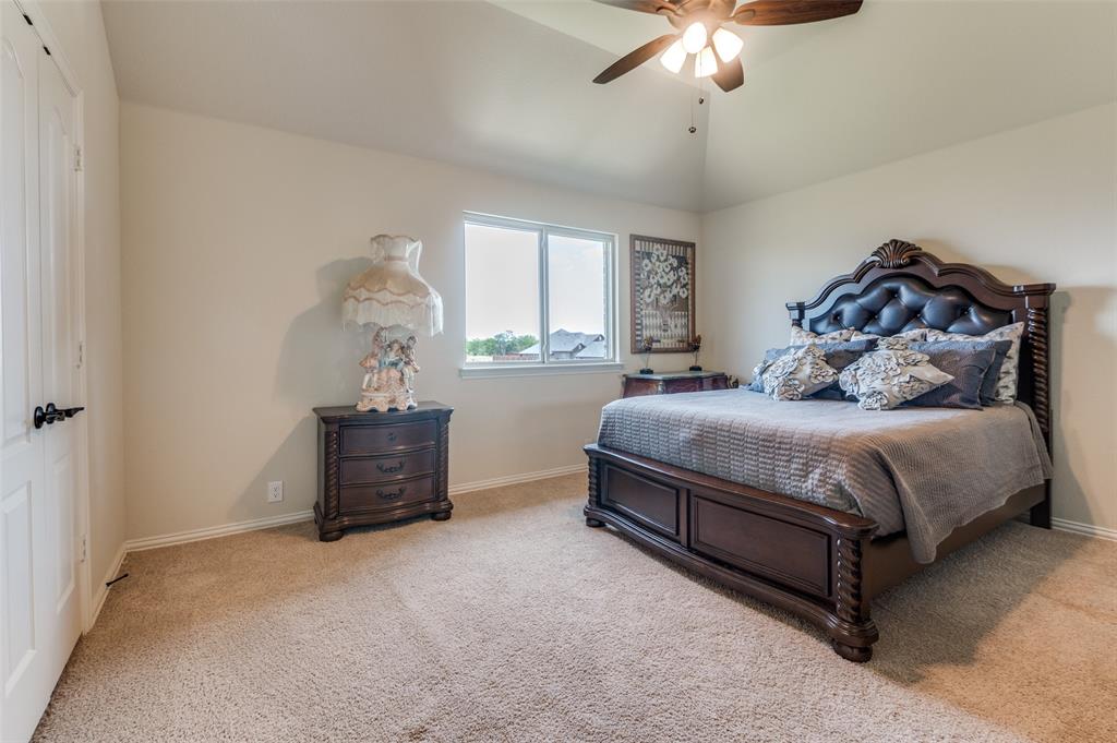 3822 Myrtle Way Kaufman, TX 75142 - Photo 32 of 39 a bedroom with a bed and a chandelier
