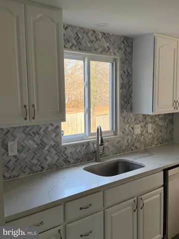 a kitchen with a sink and cabinets