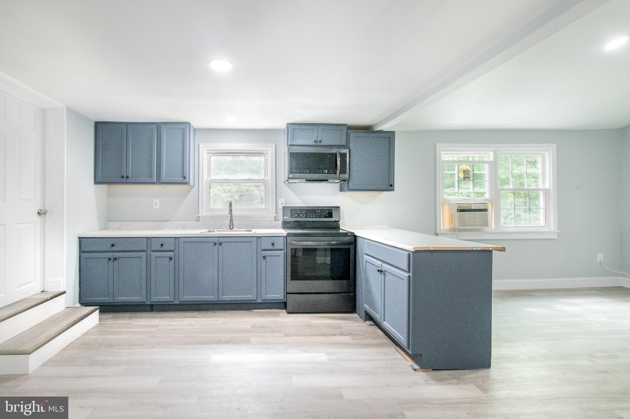 1425 South Manor Road Coatesville, PA 19320 - Photo 12 of 32 Modern kitchen with stylish blue cabinetry.