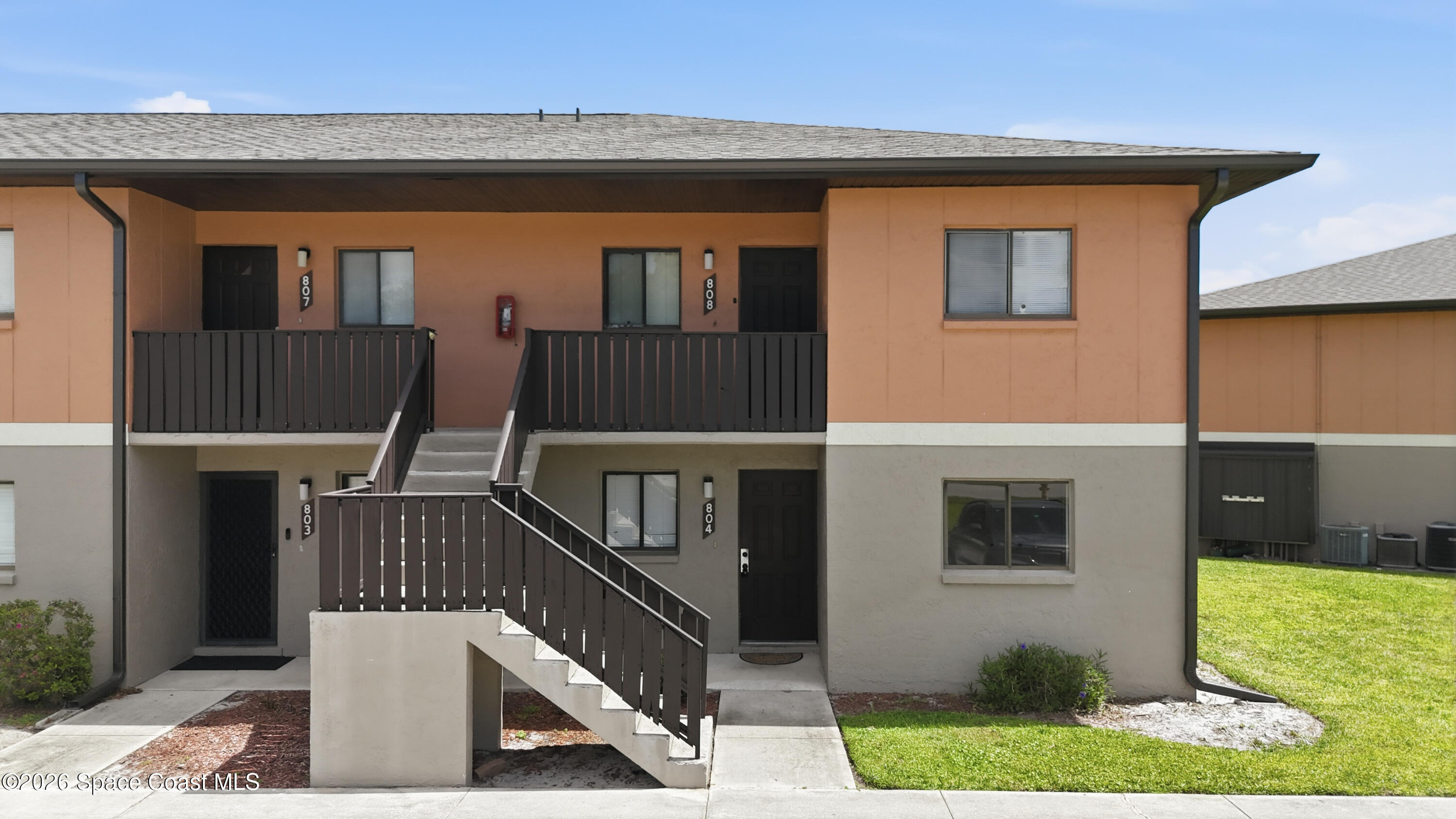1702 University Lane, Unit 804 Cocoa, FL 32922 - Photo 1 of 25 a view of balcony with small yard and wooden fence