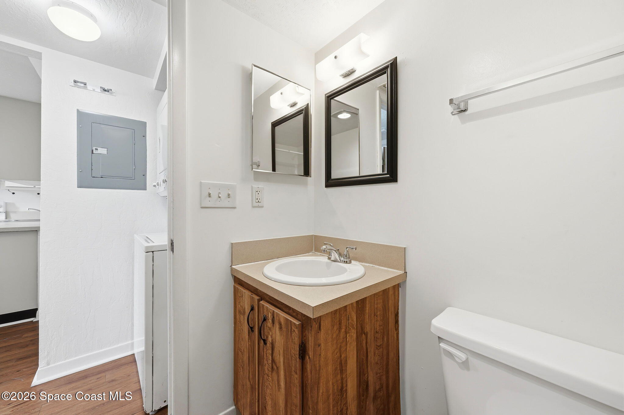 1702 University Lane, Unit 804 Cocoa, FL 32922 - Photo 13 of 25 a bathroom with a toilet sink and mirror