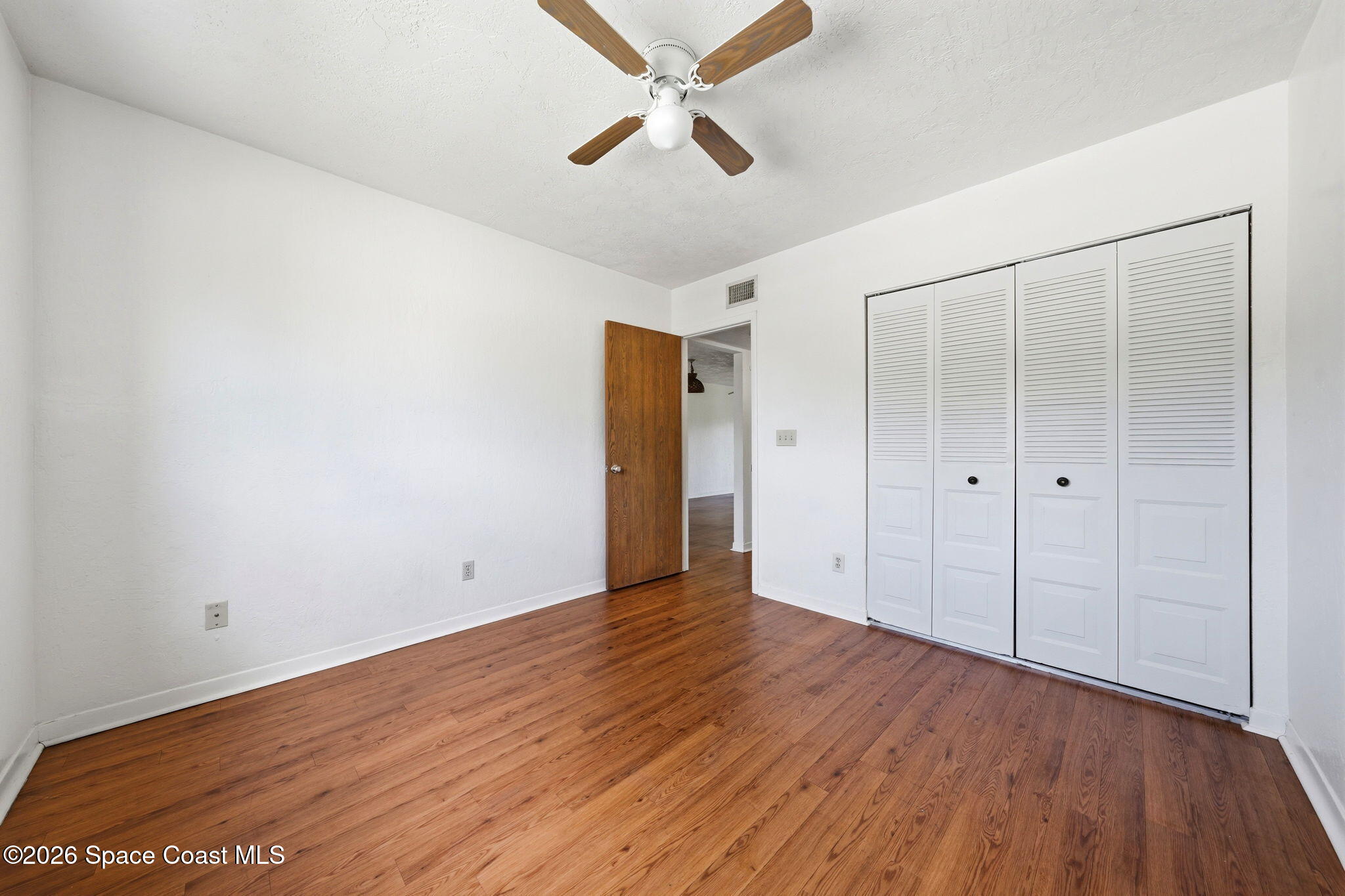 1702 University Lane, Unit 804 Cocoa, FL 32922 - Photo 15 of 25 wooden floor in an empty room
