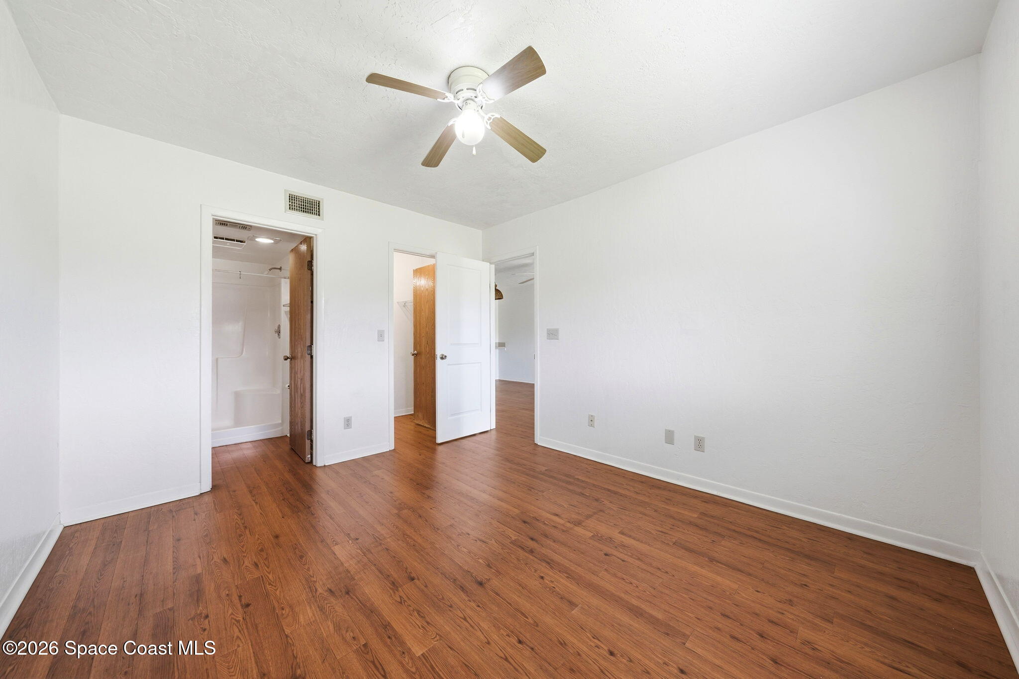 1702 University Lane, Unit 804 Cocoa, FL 32922 - Photo 17 of 25 an empty room with wooden floor and ceiling fan
