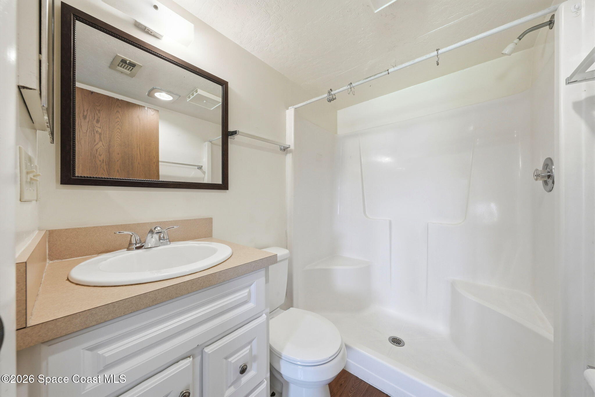 1702 University Lane, Unit 804 Cocoa, FL 32922 - Photo 18 of 25 a bathroom with a sink a toilet and shower